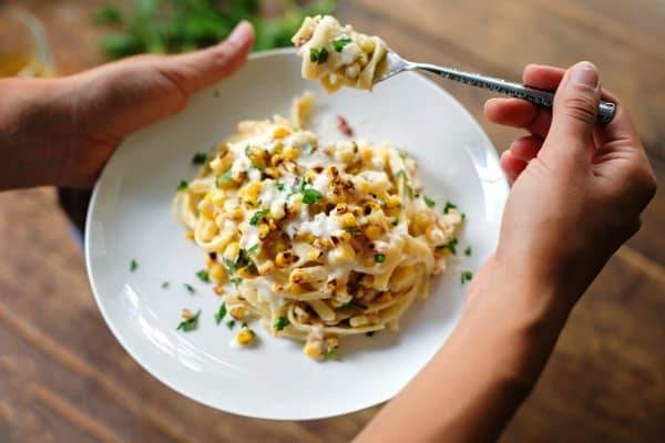 Chipotle sweet corn fettuccine on a white plate.