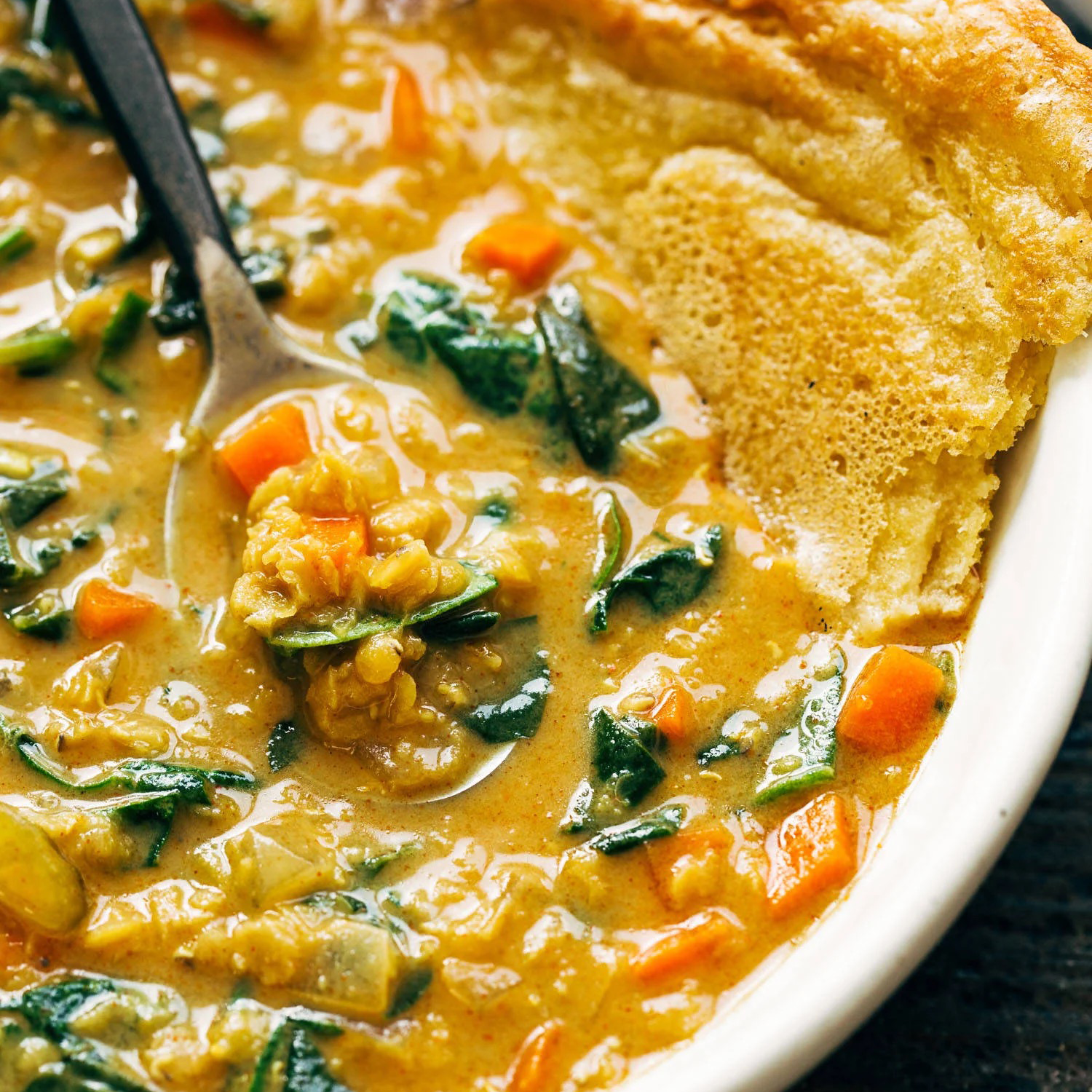 Smoky red lentil soup in a bowl.